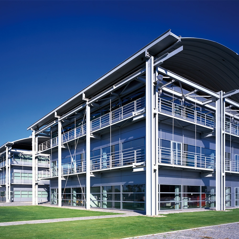 The exterior of a modern building beneath a clear blue sky.