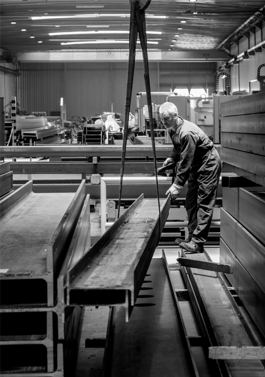 A Blocotelha worker operating machinery in the factory.