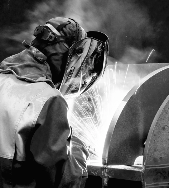 A Blocotelha worker operating machinery in the factory.